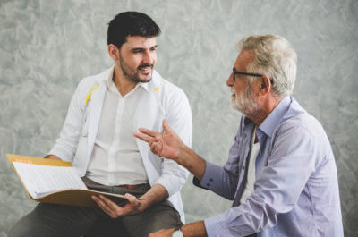 man and senior man looking at each other